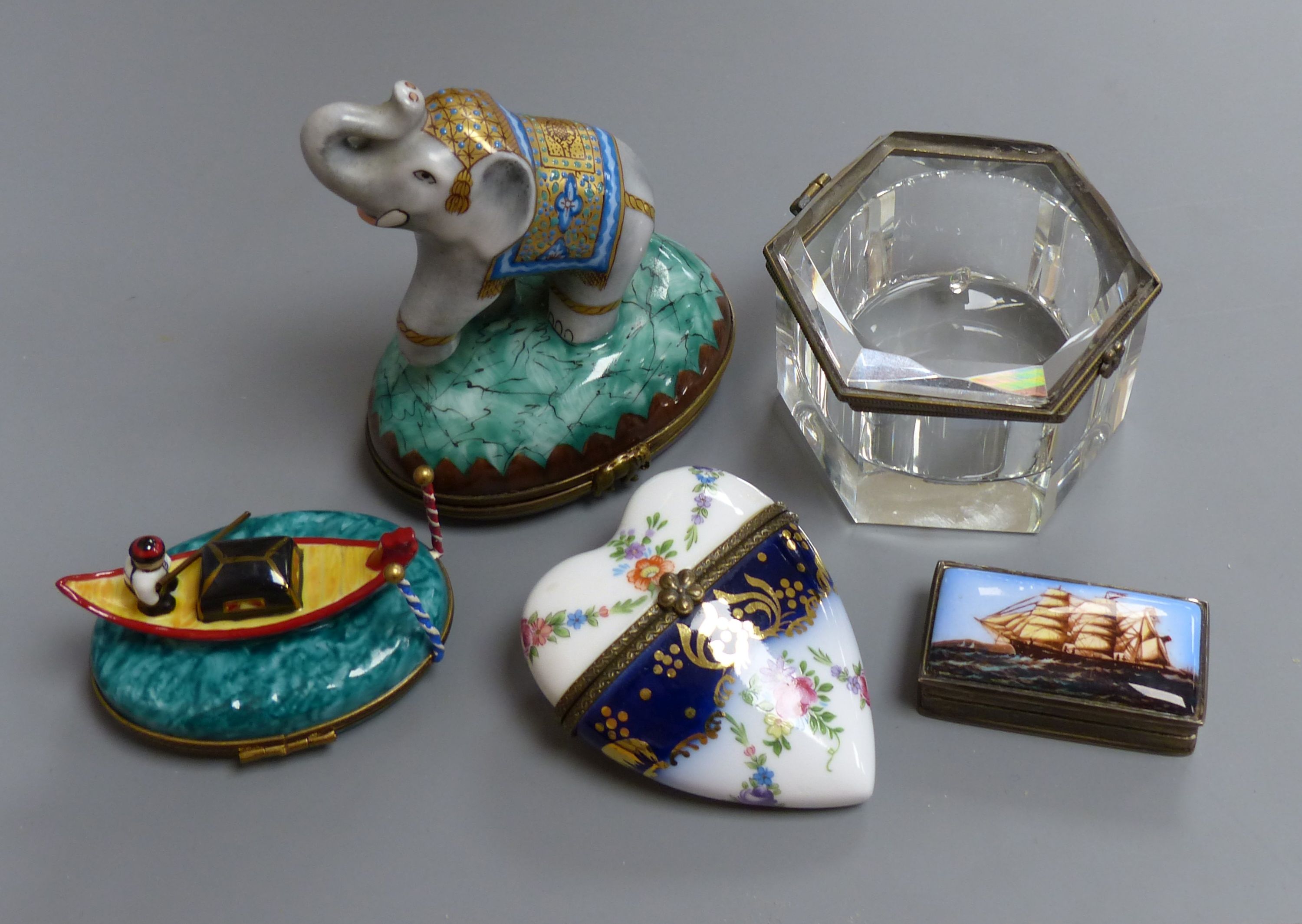 A rectangular silver snuff box, the lid with enamelled decoration of a clipper ship, a Thomas Goode bonbonniere, a Limoges bonbonniere and two other boxes